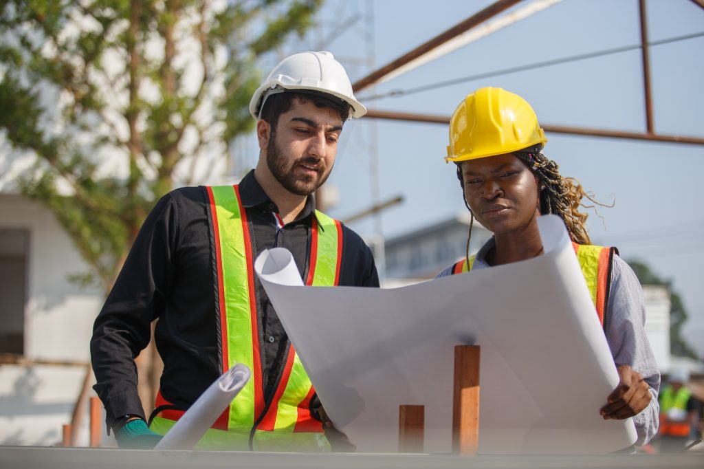 Construction civil engineer man and woman African American checking quality